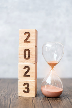 2023 block with hourglass on table. Resolution, time, plan, goal, motivation, reboot, countdown  and New Year holiday conceptsの写真素材