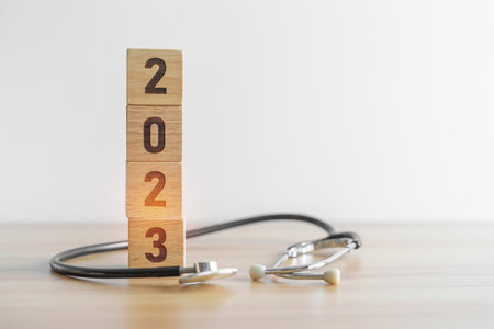 2023 Happy New Year for health care, Insurance, Wellness and medical concept. Stethoscope of doctor on tableの写真素材