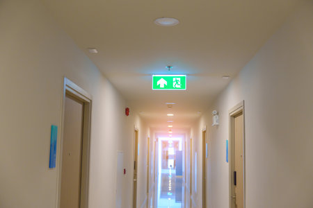 Fire Emergency exit sign on the wall background inside building. Safety conceptの写真素材