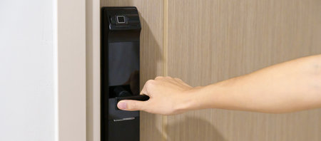 man holding handle of smart digital door lock while open or close the door. Technology, electrical and lifestyle conceptsの写真素材