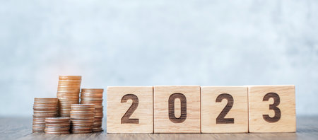 2023 year block with Coins stack. Money, Budget, tax, investment, financial, savings and New Year Resolution conceptsの写真素材