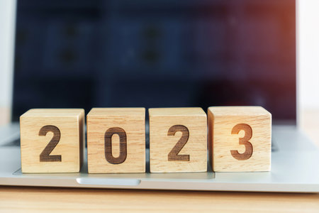 2023 Year block against computer laptop background. Goal, Target, Resolution, strategy, plan, finance, budget, motivation, and New Year start conceptsの写真素材