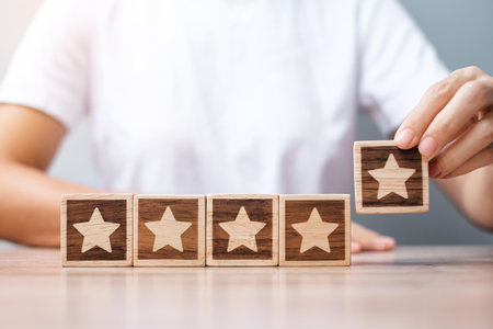 Man hand holding Star block. Customer choose rating for user reviews. Service rating, ranking, customer review, satisfaction, evaluation and feedback conceptの写真素材