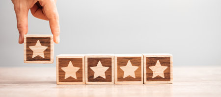Man hand holding Star block. Customer choose rating for user reviews. Service rating, ranking, customer review, satisfaction, evaluation and feedback conceptの写真素材
