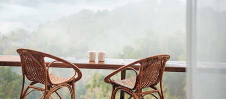 couple White mug of hot coffee or tea on wooden table in the morning with mountain and nature backgroundの写真素材