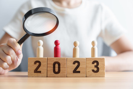 2023 block with magnifying glass and people. hiring, employee, recruitment, job and jobless conceptの写真素材