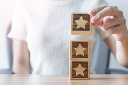 hand holding Star block. Customer choose rating for user reviews. Quality, Service rating, ranking, customer review, satisfaction, evaluation and feedback conceptの写真素材