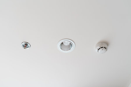 Fire Sprinkler and Smoke sensor detector mounted on roof in home or apartment. Safety and conflagration security conceptの写真素材