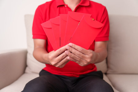 man holding Chinese red envelope, money gift for happy Lunar New Year holiday