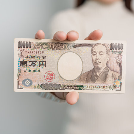 Woman hand holding Japanese Yen banknote stack. Thousand Yen money. Japan cash, Tax, Recession Economy, Inflation, Investment, finance and shopping payment conceptsの写真素材