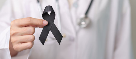 Melanoma and skin cancer, Vaccine injury awareness month and rest in peace concepts. doctor holding black Ribbonの写真素材