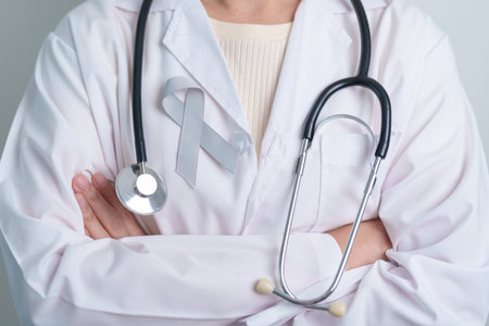 Brain Cancer Awareness May month, Doctor with grey color Ribbon for supporting life people. Healthcare and World cancer day conceptの写真素材