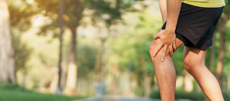 Young adult male with muscle pain during running. runner have knee ache due to Runners Knee or...