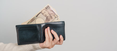 Woman hand holding Japanese Yen banknote with wallet. Thousand Yen money. Japan cash, Tax, Recession...