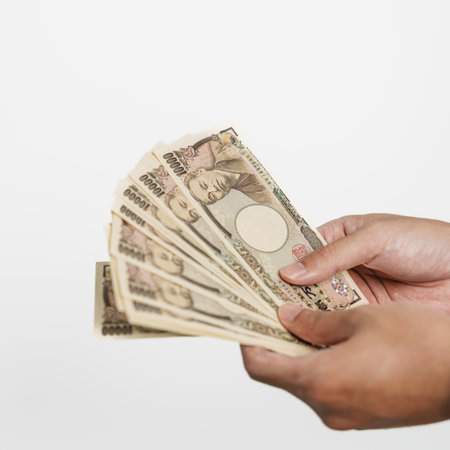 man hand holding Japanese Yen banknote stack. Thousand Yen money. Japan cash, Tax, Recession Economy, Inflation, Investment, finance and shopping payment conceptsの写真素材