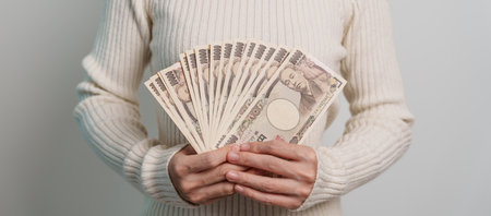 Woman hand holding Japanese Yen banknote stack. Thousand Yen money. Japan cash, Tax, Recession Economy, Inflation, Investment, finance and shopping payment conceptsの写真素材