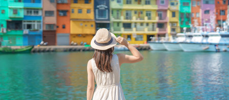 woman traveler visiting in Taiwan, Tourist with hat sightseeing in Keelung, Colorful Zhengbin Fishing Port, landmark and popular attractions near Taipei city . Asia Travel conceptの写真素材
