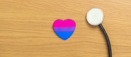 Bisexuality Celebrate Day and LGBT pride month,  LGBTQ+ or LGBTQIA+ concept. Stethoscope with purple, pink and blue heart shape for Lesbian, Gay, Bisexual, Transgender, Queer and Pansexual communityの写真素材