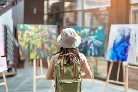 Young female tourist looking gallery exhibition. Art, Painting, photography, Inspiration and museum conceptの写真素材