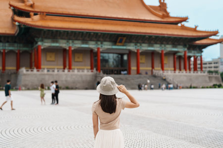 woman traveler visiting in Taiwan, Tourist with hat sightseeing in National Chiang Kai shek Memorial or Hall Freedom Square, Taipei City. landmark and popular attractions. Asia Travel conceptの写真素材