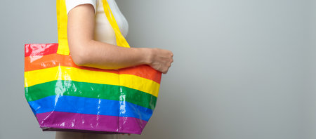 LGBT pride month concept or LGBTQ+ or LGBTQIA+ woman with Eco friendly bag with rainbow colorの写真素材
