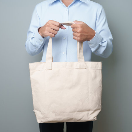 man with Eco Shopping tote bag with Copy space for text. Environmental Protection, Zero waste, Reusable, Say No Plastic, Sustainability, Eco Friendly, World Environment day and Earth day conceptの写真素材