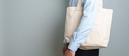 man with Eco Shopping tote bag with Copy space for text. Environmental Protection, Zero waste, Reusable, Say No Plastic, Sustainability, Eco Friendly, World Environment day and Earth day conceptの写真素材