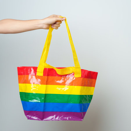 LGBT pride month concept or LGBTQ+ or LGBTQIA+ woman with Eco friendly bag with rainbow colorの写真素材