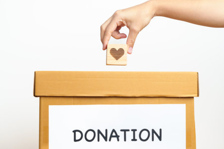 Organ Donation, Charity, Volunteer, Giving and blood Concept. Hand holding heart into donate box for...
