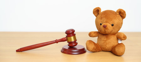 Children, Kid and Family Law concepts. toy bear with gavel justice hammer on desk in courthouse.の写真素材