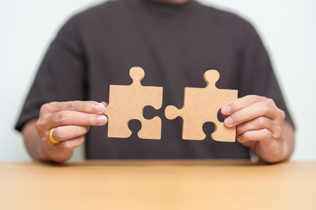 Hand connecting couple puzzle piece. Business Solving, mission, challenge, success, goals, target...