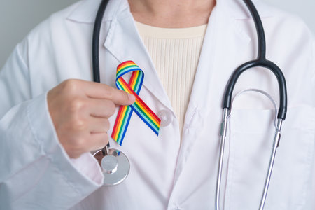 Doctor with LGBTQ Rainbow ribbon for Support Lesbian, Gay, Bisexual, Transgender and Queer community and happy Pride month conceptの写真素材