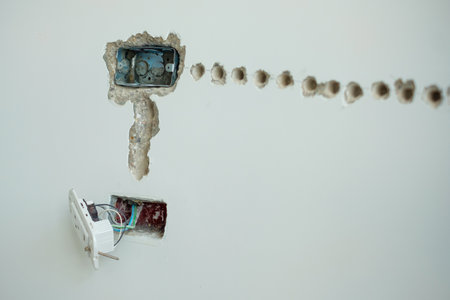 Electrical Wiring under plaster, hidden installation cables for socket to a concrete. Renovation,...