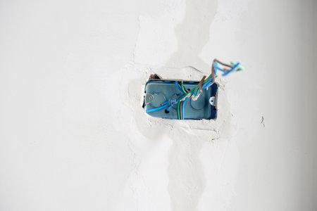 Electrical Wiring under plaster, hidden installation cables for socket to a concrete. Renovation, Repair and development of home and apartment conceptsの写真素材