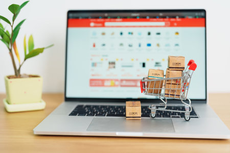 Boxes with shopping cart on a laptop computer. online shopping, Marketplace platform website, technology, ecommerce, shipping delivery, logistics and online payment conceptsの写真素材