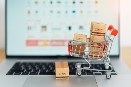 Boxes with shopping cart on a laptop computer. online shopping, Marketplace platform website, technology, ecommerce, shipping delivery, logistics and online payment conceptsの写真素材