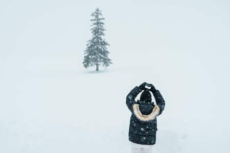 Woman tourist Visiting in Biei, Traveler in Sweater sightseeing Christmas tree with Snow in winter season. landmark and popular for attractions in Hokkaido, Japan. Travel and Vacation conceptの写真素材
