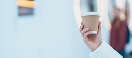woman tourist holding hot Coffee or Tea paper cup with snow in winter season during travel in Niseko. landmark and popular for attractions in Hokkaido, Japan. Travel and Vacation conceptsの写真素材