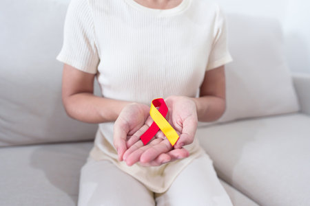 woman holding Red and Yellow ribbon. World hepatitis day awareness month, 28 July, Liver cancer, Jaundice, Cirrhosis, Failure, Enlarged, Hepatic Encephalopathy and Health conceptの写真素材
