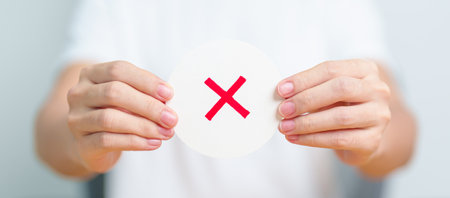 Woman show Wrong symbol paper. True and false, accept and rejected, evaluation, Vote, Poll, Yes or No and Survey conceptsの写真素材