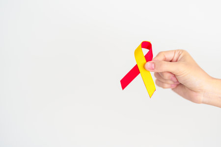 woman holding Red and Yellow ribbon. World hepatitis day awareness month, 28 July, Liver cancer,...