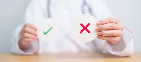 Doctor show Wrong symbol paper. True and false, accept and rejected, evaluation, Diagnosis, Vote, Poll, Yes or No, Health, Medical and Survey conceptsの写真素材