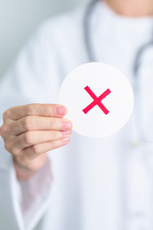 Doctor show Wrong symbol paper. True and false, accept and rejected, evaluation, Diagnosis, Vote, Poll, Yes or No, Health, Medical and Survey conceptsの写真素材