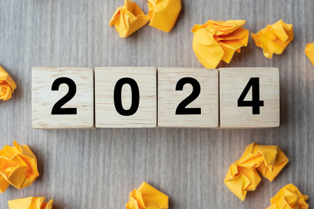 2024 text wood cube and crumbled paper  on wooden table background. New Year New Ideas, Creative, Innovation, Imagination, inspiration, Resolution, Strategy and goal conceptの写真素材