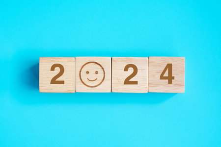 Smile face block with 2024 text on blue background. Satisfaction, feedback, Review and New Year conceptsの写真素材
