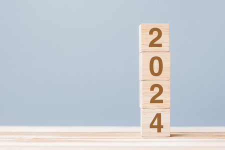 wooden cube block with 2024 text on table background. Resolution, plan, review, goal, start and New Year holiday conceptsの写真素材