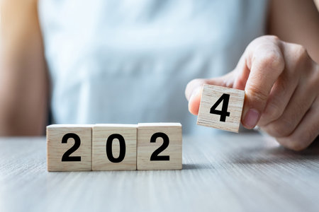 hand flipping block 2023 to 2024 text on table. Resolution, strategy, plan, goal, motivation, reboot, business and New Year holiday conceptsの写真素材