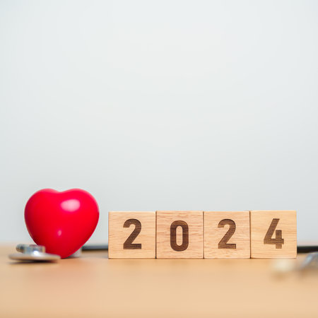 2024 Happy New Year for health care, Insurance, Wellness and medical concept. Stethoscope of doctor on tableの写真素材