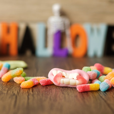 Happy Halloween day with ghost candies, pumpkin bowl, Jack O lantern and decorative (selective...