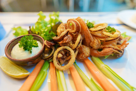 Italian dish fried seafood, octopus, shrimp, squid and lemon sliced. Italy fast food and appetizers
